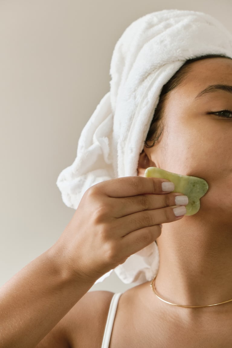 Woman with Wrapped Hair in Towel Using Facial Gua Sha